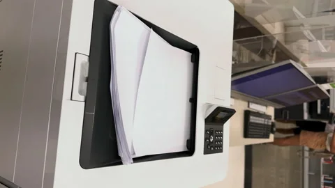 Working printer.View from above of MFP printer printing something on white paper Stock Footage 248867642