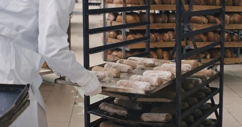 Working process in a big bakery man preparing the raw bred to be transported to Stock Footage 123005801