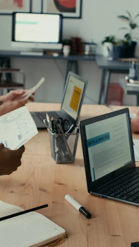 Working Process of Colleagues Typing on Laptops and Exchanging Papers in Office Stock Footage 302374054