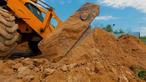 Working process at a construction site. Tractor bucket close up. A tractor digs Video stock 192316106