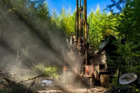 Working process of drilling a geological well. Dust when drilling borehole Stock Photos