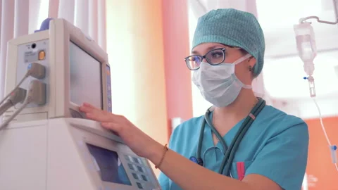 Working process of a female doctor during which she is setting parameters on a Stock Footage 88622995