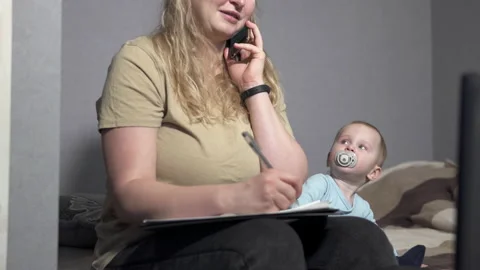 Working process at home of a young mother. Self-isolation of family life. Stock Footage 145587023