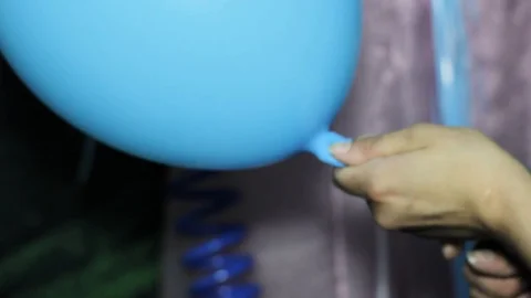 Working process of inflating a balloon with gas helium from a metal gas cylinder Stock Footage 93025913