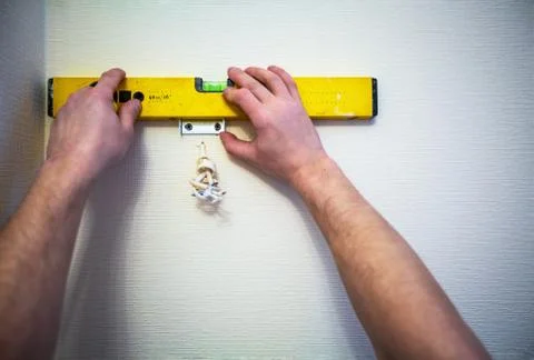 Working process of installing lamp or candelabrum on the wall with old yellow Stock Photos