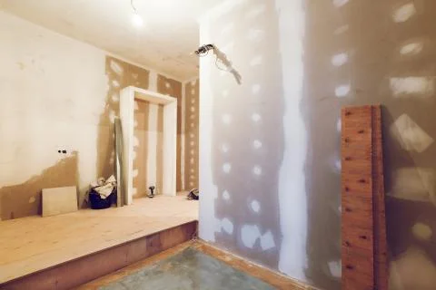 Working process of installing plasterboard or drywall for making gypsum walls in Stock Photos