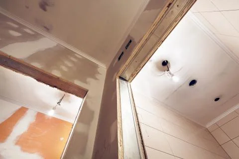 Working process of installing plasterboard or drywall for making gypsum walls in Stock Photos