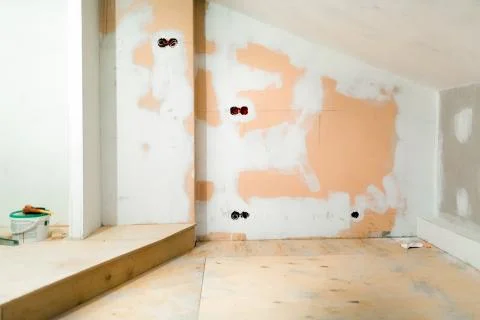 Working process of installing plasterboard or drywall for making gypsum walls in Stock Photos