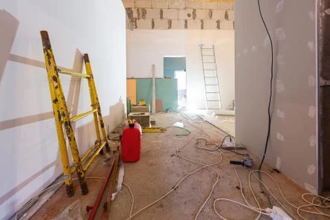Working process of installing plasterboard or drywall for making gypsum walls in Stock Photos