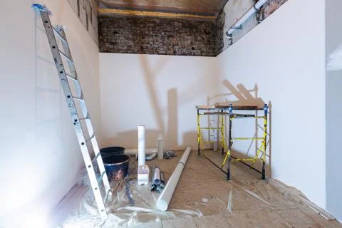 Working process of installing plasterboard or drywall for making gypsum walls in Stock Photos