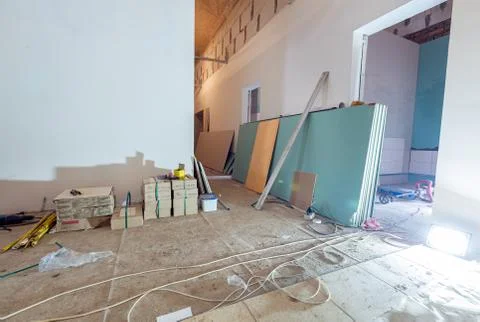 Working process of installing plasterboard or drywall for making gypsum walls in Stock Photos