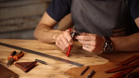 Working process of the leather belt in the leather workshop. Man holding Stock Footage 80659324