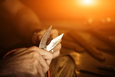 Working process of the leather belt in the leather workshop. Man holding Stock Photos