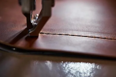 Working process of leather craftsman. Tanner or skinner sews leather on a Foto stock