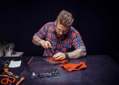 Working process of the leather wallet in the leather workshop. Stock Photos