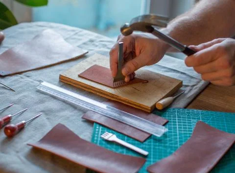 Working process of the leather wallet in the leather workshop Stock Photos
