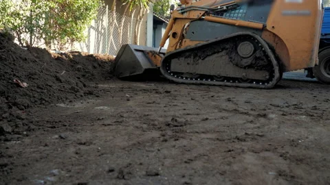 The working process of picking up some soil by a tractor loader Stock Footage 147850798