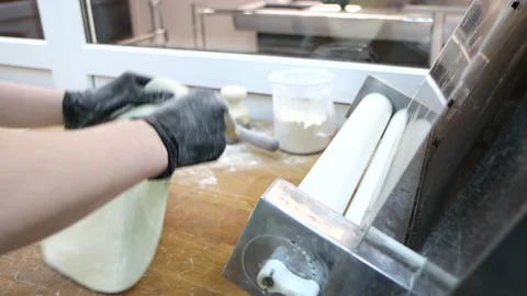 Working process with special rolling machine for stretching dough Stock Footage 181020342
