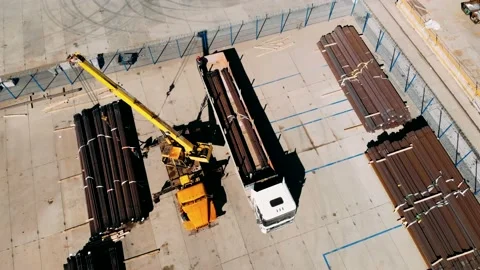 The working process in a warehouse with a metal. Workers unload a metal in a Stock Footage 153147341