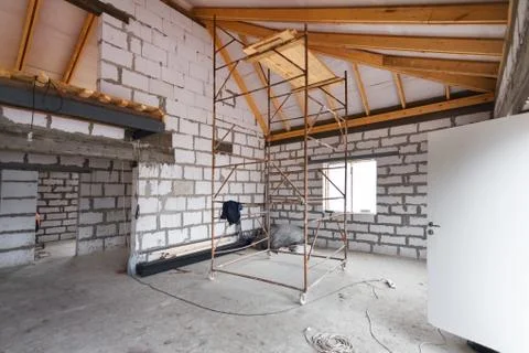 Working process of warming inside part of roof with using erecting stage in Stock Photos