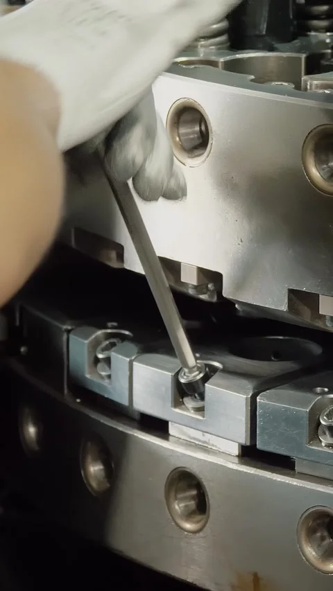 Working process. worker, in protective gloves, unscrews a bolt from a part on a Stock Footage 318684755