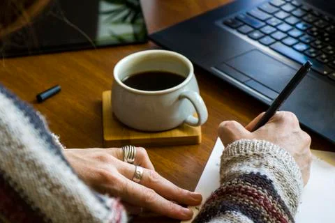 Working process, workspace and workspace, hand, coffee and notebook or laptop Stock Photos