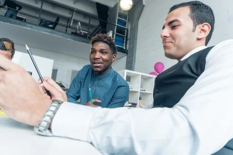 Working process. Young businessmen of different nationalities at the meeting. Stock Photos