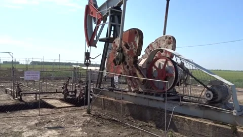 Working Pumpjack Oil Well in Rural Landscape – 4K Stock Video Stock Footage 335303209