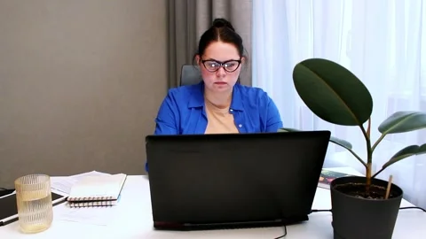 Working remotely from cozy home interior. Woman enjoys location independent Stock Footage 327457793