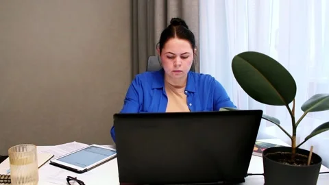 Working remotely from cozy home interior. Woman enjoys location independent Stock Footage 328370735