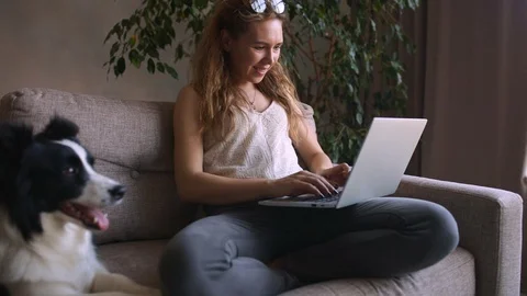 Working Remotely. CRANE SHOOT Young Woman and her dog freelancer working from Video stock 127784264