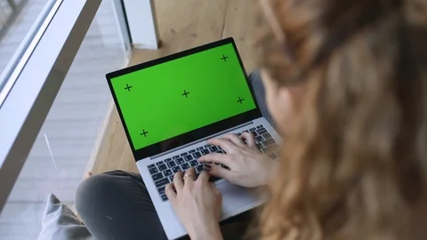 Working Remotely. GREEN SCREEN with tracking dot. Young Woman working from home Stock Footage 127784077