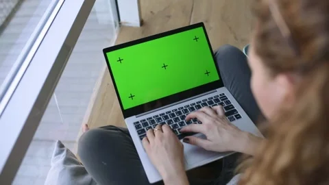 Working Remotely. GREEN SCREEN with tracking dot. Young Woman working from home Stock Footage 133282184