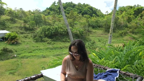 Working remotely in hammock surrounded by nature Stock Footage 307078626