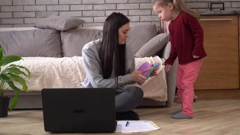 Working remotely as a parent. Work-at-Home Job. Stay-at-Home Mom. Mother works Stock Footage 153124122