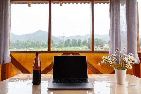 Working remotely on vacation or freelancing with a laptop, a beer and a pictu Stock Photos