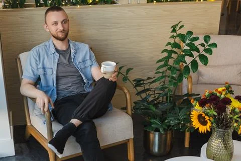 Working remotely while enjoying coffee in a modern office setting with plan.. Fotos Stock