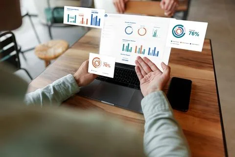 Working on reports and data analysis using CRM software in a modern office Stock Photos