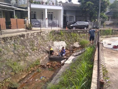 Working on River Utilization Project Into a Fish Pond Stock Photos