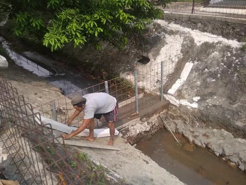 Working on River Utilization Project Into a Fish Pond Stock Photos