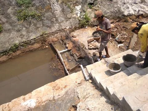 Working on River Utilization Project Into a Fish Pond Stock Photos