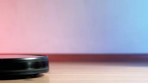 Working robot vacuum cleaner. red and blue lights on the wall. no furniture. 動画素材 135952975