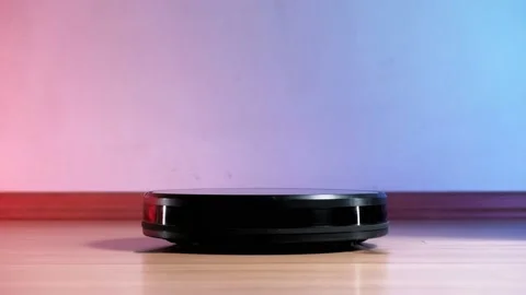 Working robot vacuum cleaner. red and blue lights on the wall. no furniture. Stock Footage 135952981