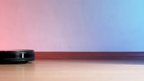 Working robot vacuum cleaner. red and blue lights on the wall. no furniture. Stock Footage 135952989