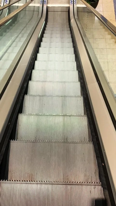Working rolling escalator metal materials glass railings shopping mall Stock Footage 278395942