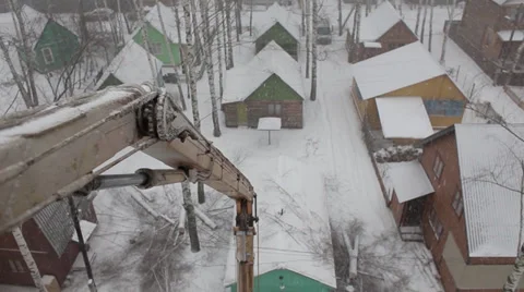 Working rose to a height to cut down a tree. View from the ski lift. Winter. Stock Footage 33959971