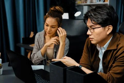 Working sales manager pointing to missing report data with coworker. Infobahn. Stock Photos