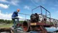 Working senior man in a helmet and work clothes near the water treatment plant HD Footage
