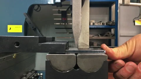 Working with sheet metal on CNC hydraulic press brake. Bending sheet metal Stock Footage 166090182
