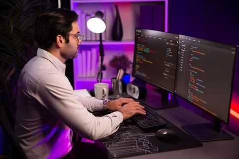 Working smart IT developer analyzing data software development on pc. Surmise. Stock Photos